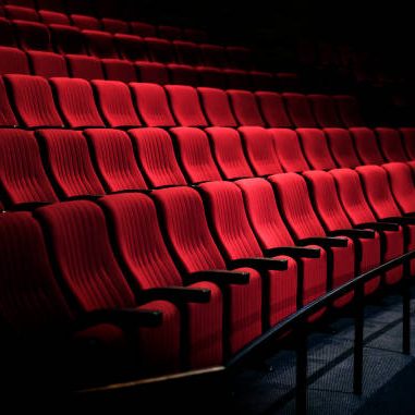 Rows of red seats in a theater